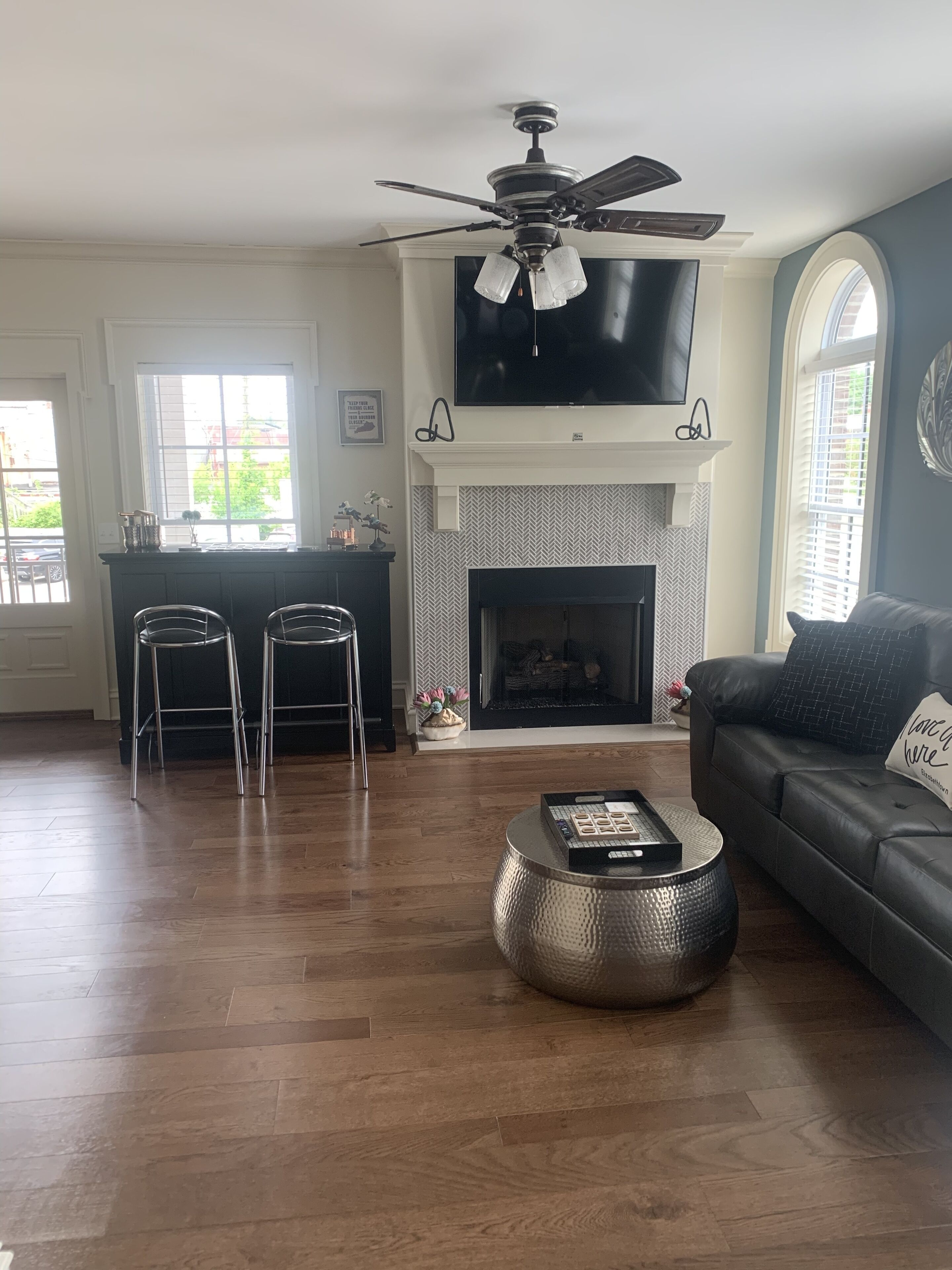 A living room with a fireplace, a television, and a sofa.