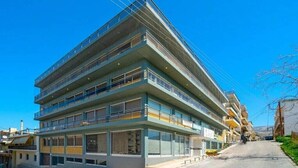 A multi-story building with balconies, large windows, and a flat roof. - Luxury maisonette in Ilioupoli (Ilioupoli)