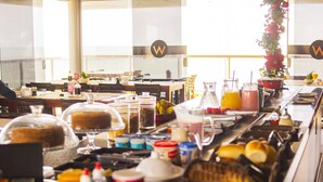 A buffet setup with various food items and beverages.