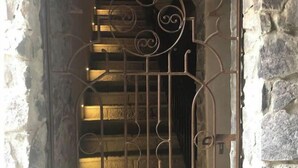 A metal gate with intricate designs, leading to a stone staircase. - Incredible Loft in ValQuirico!  (Xoxtla)