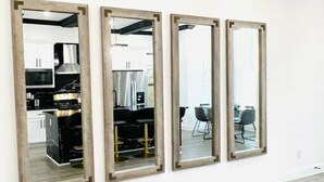 A modern interior with a large mirror and a fur rug on the floor. - Alim Pad 3: Brand New Modern house near downtown (Houston)