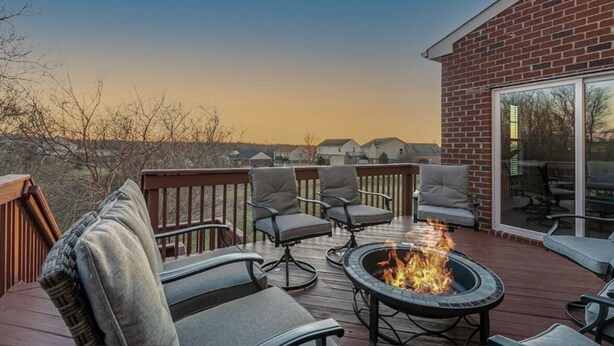 A deck with outdoor seating and a fire pit.