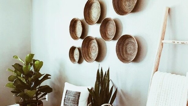 A room with a wooden bench, a white wall, and a white towel hanging on a rack. - 250picnics (Kigali)