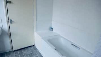 Bathtub, towels, toilet paper