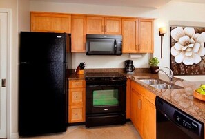 Kitchen features a stove, oven, microwave, dishwasher, sink, and coffee maker.