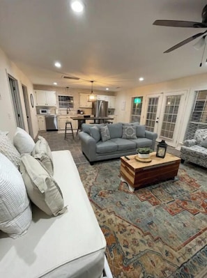 Relax in this stylish living room with a plush sofa, coffee table, and dining area.