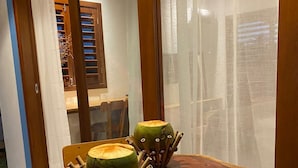 A wooden table with two carved coconut sculptures on it. - Pousada Corália (São Miguel dos Milagres)