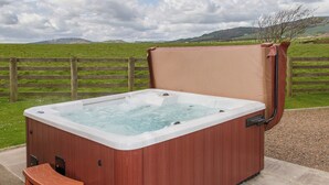 A hot tub with a wooden exterior, a cover, and a step stool. - Conveniently located just 500 yards from the sandy beach. (Southerness, near Dumfries)