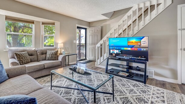 A living room with a sofa, coffee table, and TV.