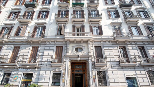 A multi-story building with a central entrance, balconies, and a sign for 'Vilanova'. - Napul 19 - Quadrupla (Naples)