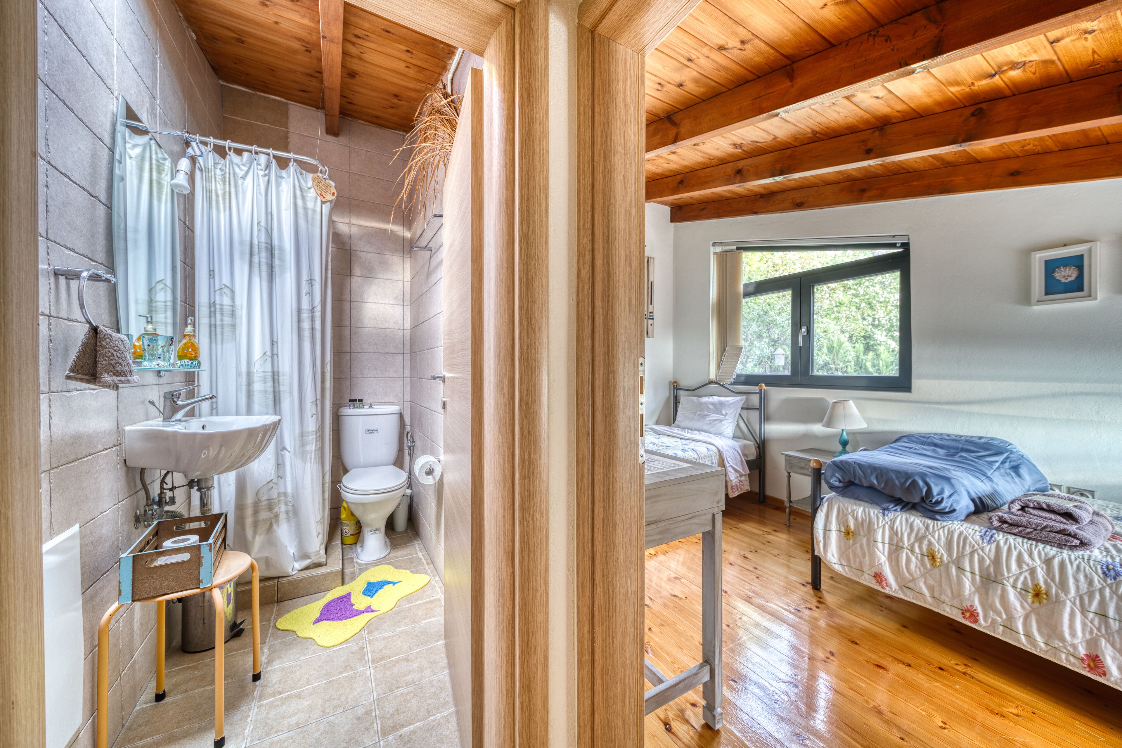 A bathroom with a sink, toilet, and shower curtain.