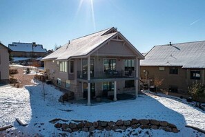 Enjoy the expansive balcony with a view from the upper floor of this two-story residence.