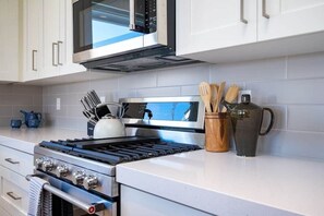 Enjoy cooking in this well-equipped kitchen with a microwave, oven, and stove.