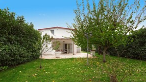 A house with a red roof, surrounded by a well-maintained lawn and a hedge. - 2534 Appartamento Orange - Villa Sogno Blu by Barbarhouse (San Vito dei Normanni)