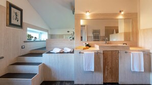 A modern bathroom with a large mirror, two sinks, and a wooden vanity.