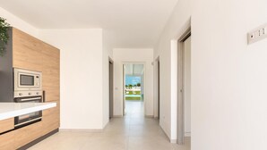 A modern kitchen with a built-in microwave, oven, and dishwasher. - 3088 Villa Alceste by Perle di Puglia (San Vito dei Normanni)