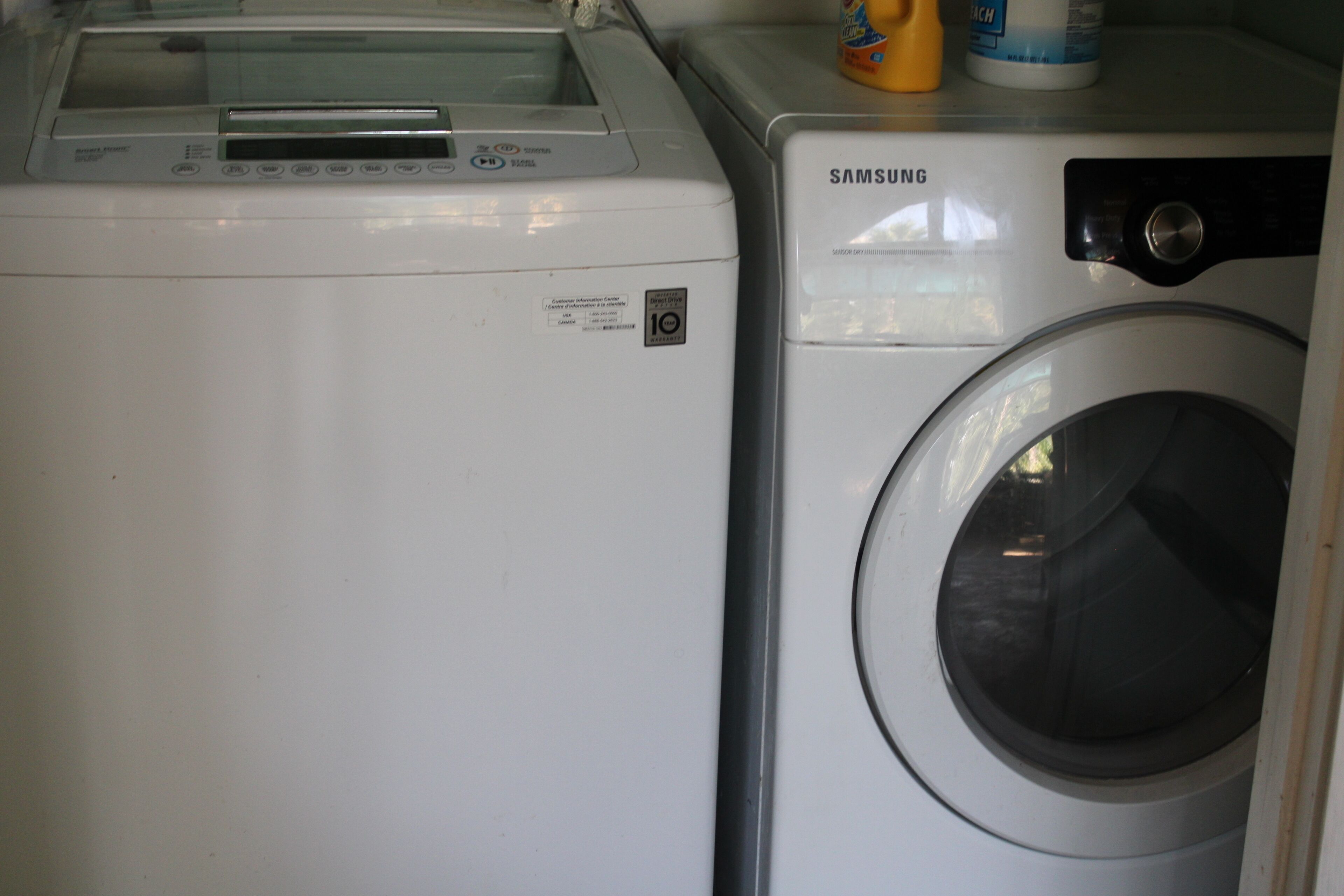 Full sized washer and dryer located inside pool cabana