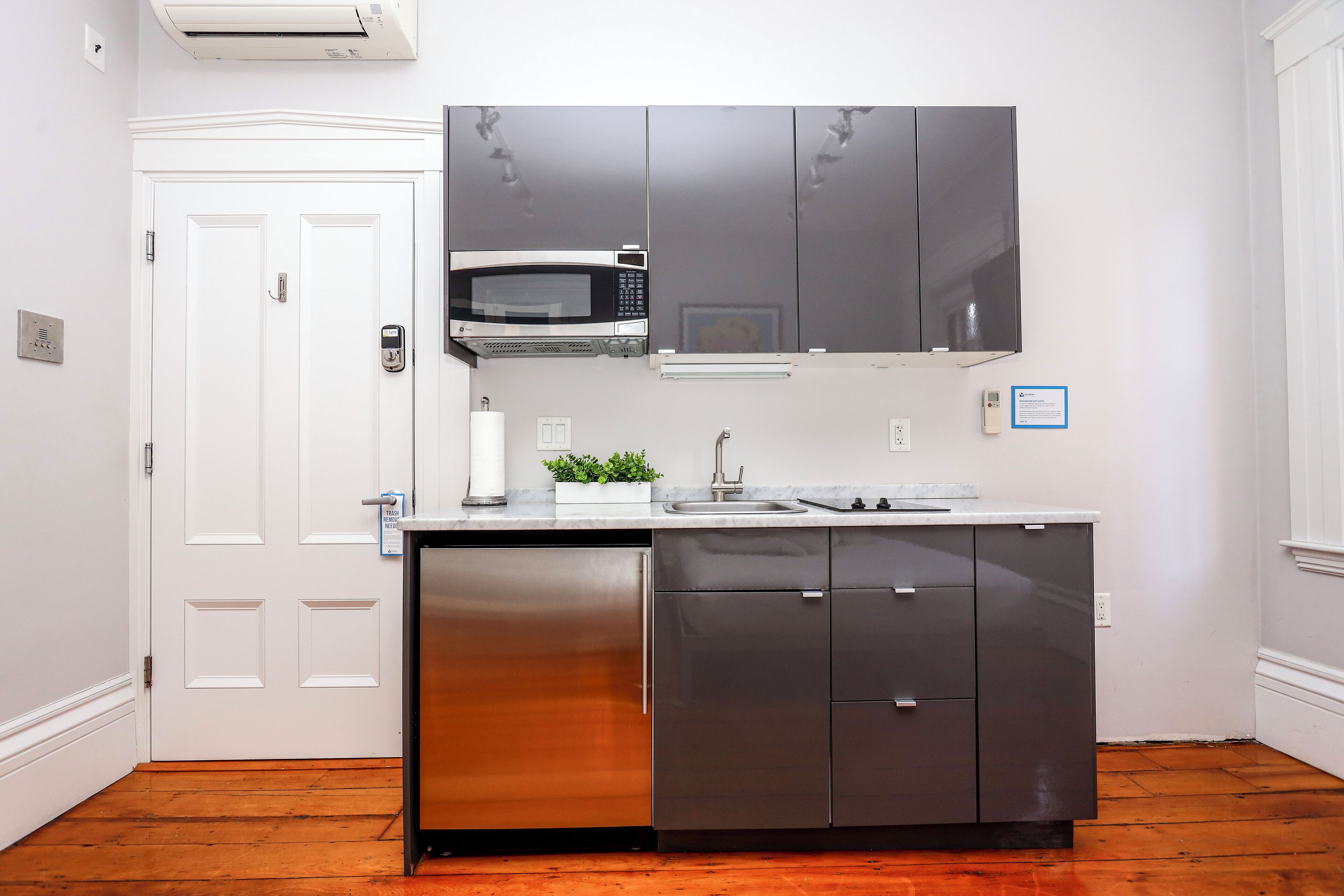 A modern kitchen with stainless steel appliances, a built-in microwave, and a sink.