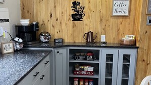 Una cocina con paneles de madera, una barra de café y una decoración temática de café.