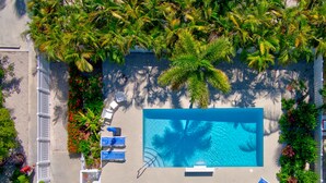 An aerial view of a pool area with a large pool, several lounge chairs, and palm trees. - Bungalow #4 - 2 Bed/1 Bath & Pool in Islamorada (Islamorada)
