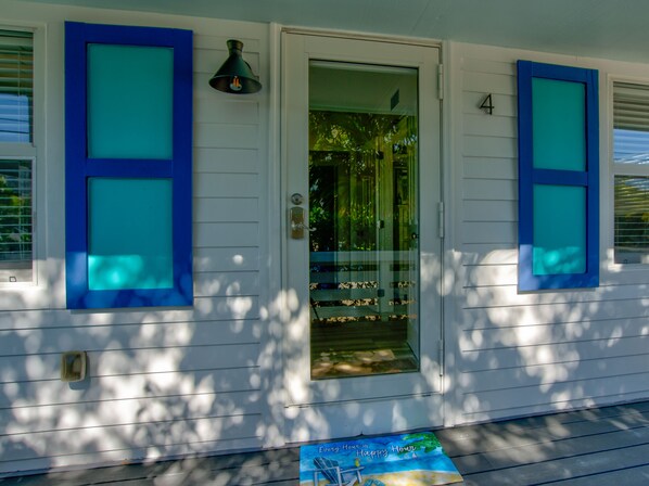 A house with a front door, blue shutters, and a number '4' on the door. - Bungalow #4 - 2 Bed/1 Bath & Pool in Islamorada (Islamorada)