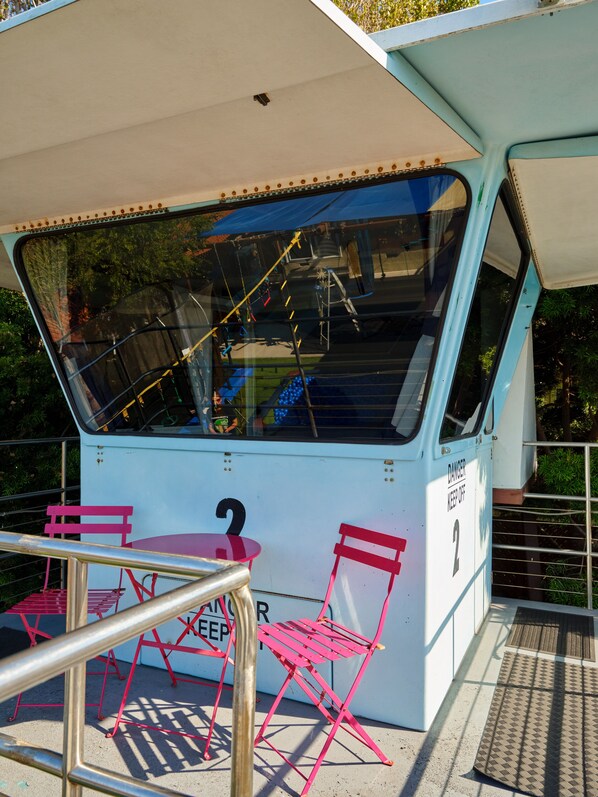 A small boat with a covered seating area, numbered 2, and a warning sign that says "DANGER KEEP OFF."