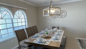 A dining room with a wooden table set for six, surrounded by upholstered chairs. - Large Remodeled Central Located Minutes to the Beach & Downtown Free Big Parking (Pensacola)