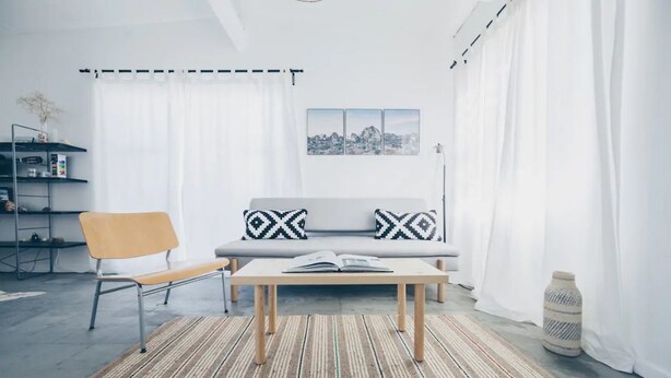 A modern living room with a sofa, a bench, a coffee table, and a rug. - Pink, Architect-Appointed House! 3 min from JTNP. (TWENTYNINE PALMS)