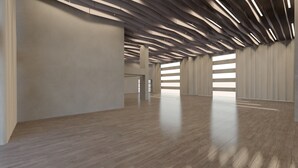 A spacious, modern interior with a high ceiling and wooden flooring.