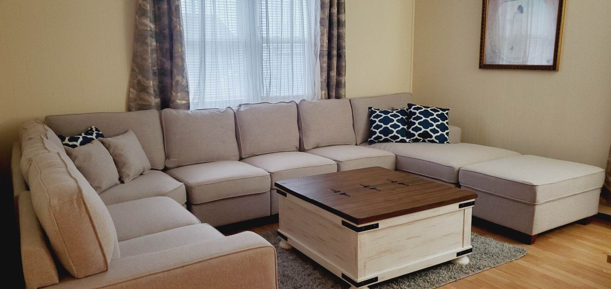 A L-shaped sectional sofa with a wooden coffee table in a living room.