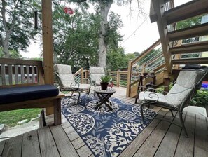 Relax on the deck with comfortable seating and a scenic view.