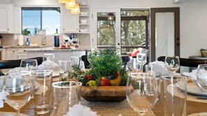 A dining table set with wine glasses and a centerpiece of fresh fruits and greenery. - 5BR/Heated Pool/Hot Tub/Fire Pit/Views/Sauna/Pets OK (Sedona)