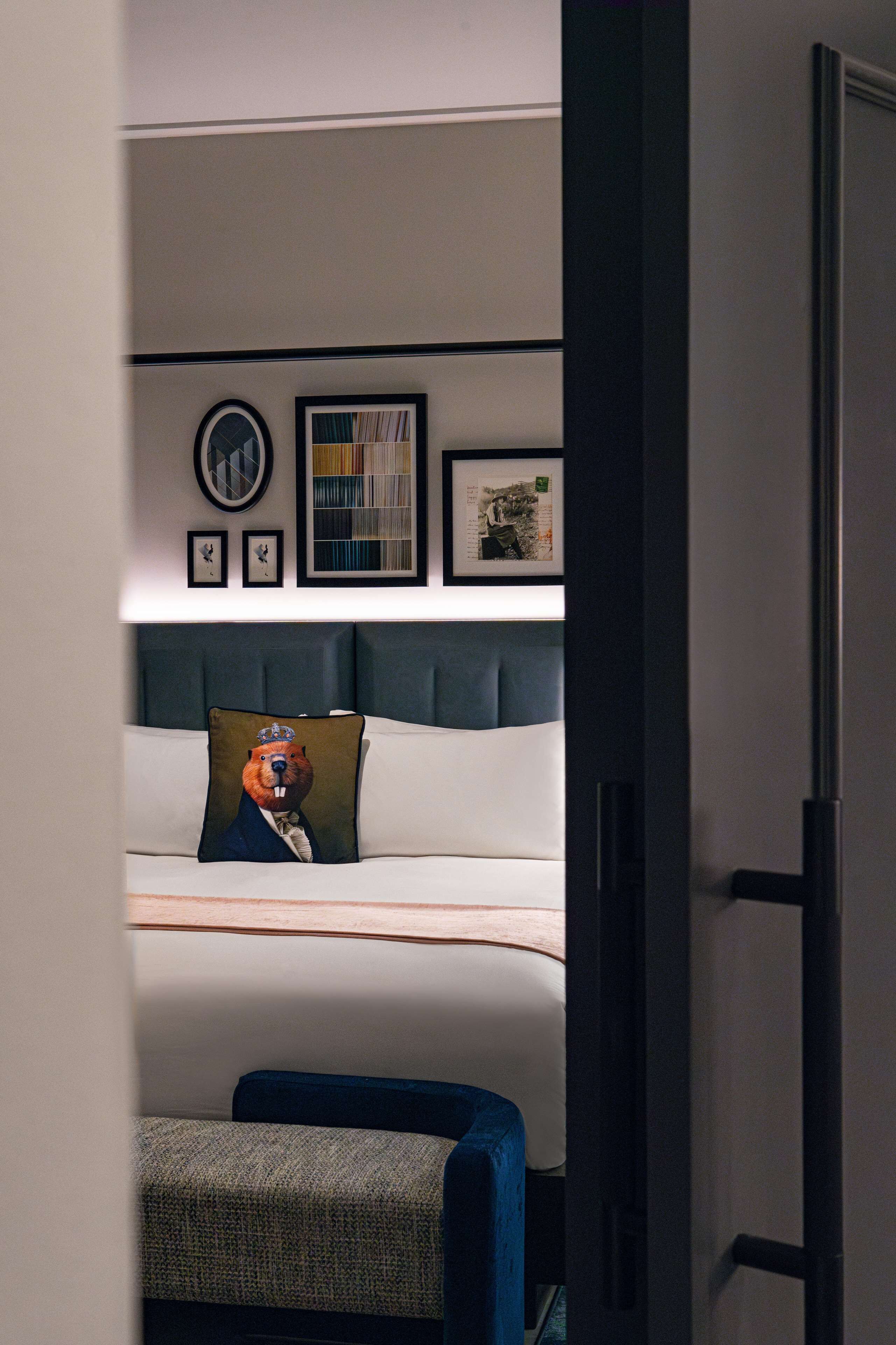 A bedroom with a bed, a headboard, a bedside table, and a chair.