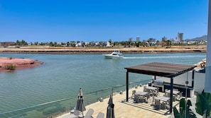 Relax by the tranquil water body, where you can enjoy outdoor dining, socializing, or take in the surrounding landscape.