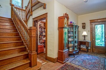 A picture of the stairs that lead to the top floor, reading nook, and the entry way from the front of the home.
