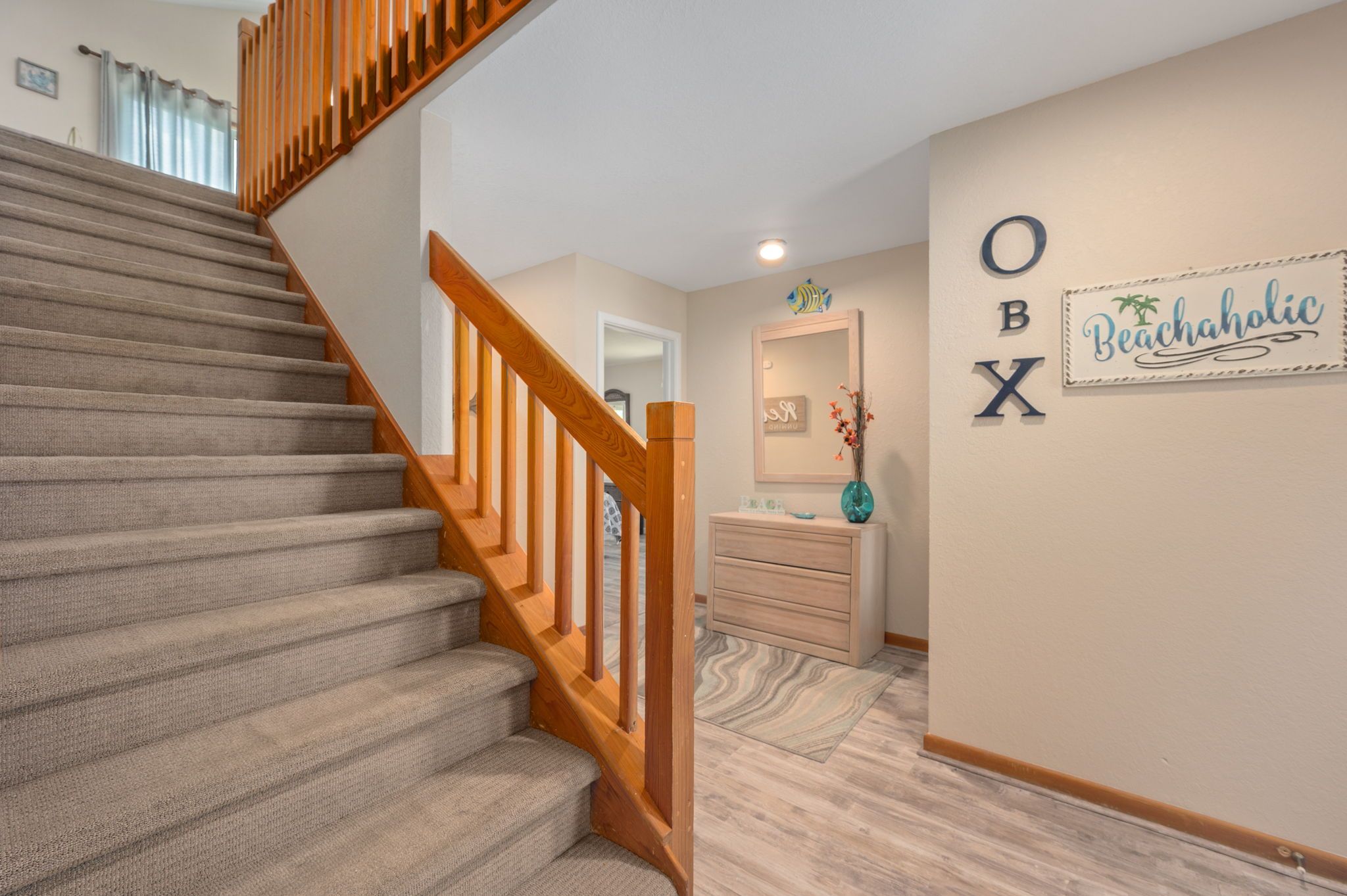 A staircase with a wooden handrail leading to a landing.