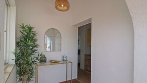 A hallway with a potted plant, a glass console table with a bowl and a framed picture, and a mirror on the wall. - Wonderful private villa for 4 guests with A/C, WIFI, private pool, TV, patio and pets allowed (Benissa)