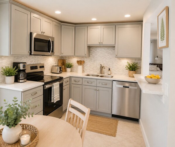 A modern kitchen with stainless steel appliances, a microwave, and a dishwasher. - Private Golden Beach access on Venice Island (Venice)