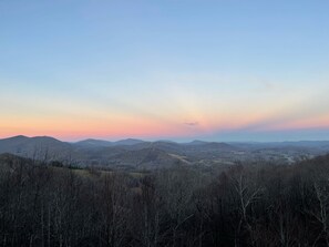 A panoramic view of a mountainous landscape with a clear sky.