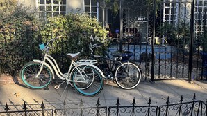 Una bicicleta estacionada frente a un edificio con una puerta de metal y un cartel que dice "2217".