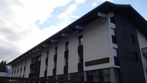 A modern building with a flat roof and large windows. The building has a sign that reads "LE BIONNASSAY".