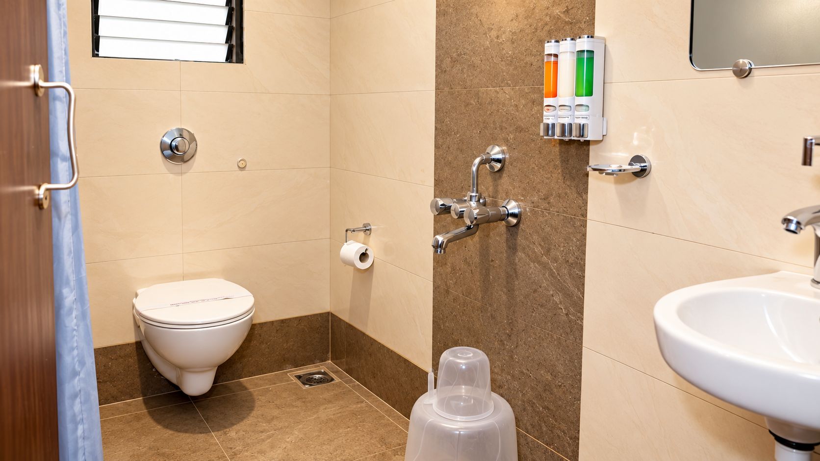 A bathroom with a toilet, sink, and shower.