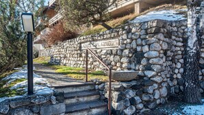 A stone staircase leading up to a building with a sign reading 'Gisella St. Grohze.'