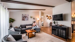 A modern living room with a sofa, armchairs, a coffee table, and a TV. - Escape to a beautiful country getaway (Philomath)