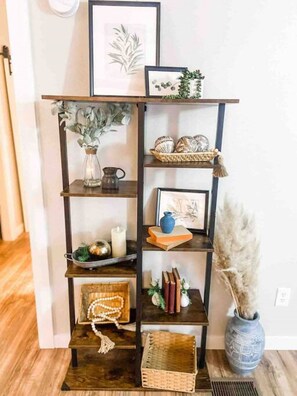 A wooden shelving unit with various decorative items and a vase. - Escape to a beautiful country getaway (Philomath)
