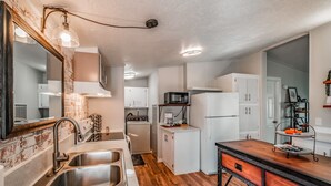 A compact kitchen with a sink, stove, microwave, and refrigerator. - Escape to a beautiful country getaway (Philomath)