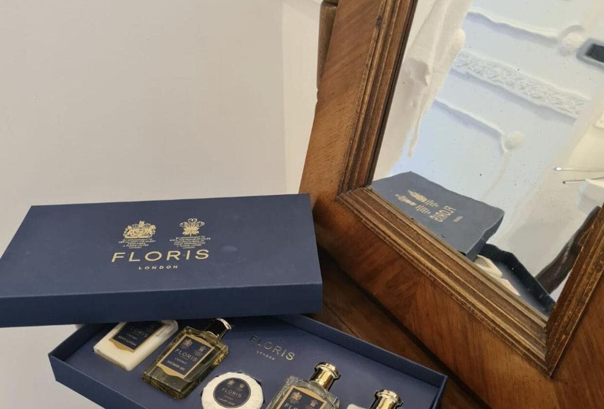 A blue box with 'FLORIS LONDON' branding, containing perfume bottles and a small box.