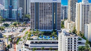 A hotel with a modern design, featuring a large central atrium and multiple balconies. - Your Stay In Surfers (Surfers Paradise)