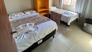 A bedroom with two beds, a wooden wardrobe, a window with curtains, and a ceiling fan. - Pousada Mar do Sonho Praia (Ipojuca)