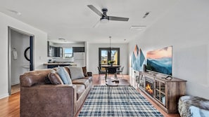 A modern living room with a sofa, coffee table, and a fireplace.